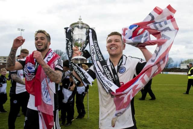 Ayr's Craig Moore with the Ladbrokes League One trophy. SNS/Sammy Turner