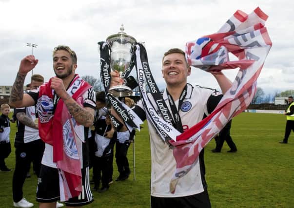 Ayr's Craig Moore with the Ladbrokes League One trophy. SNS/Sammy Turner