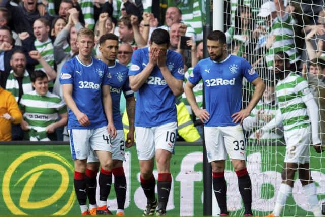 Rangers' players are left dejected after the fourth goal. Picture: SNS