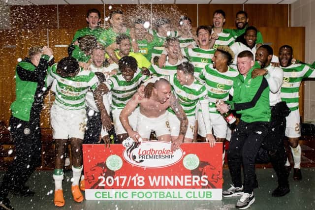 Celtic's victorious stars celebrate in the dressing room after winning the league. Picture: SNS