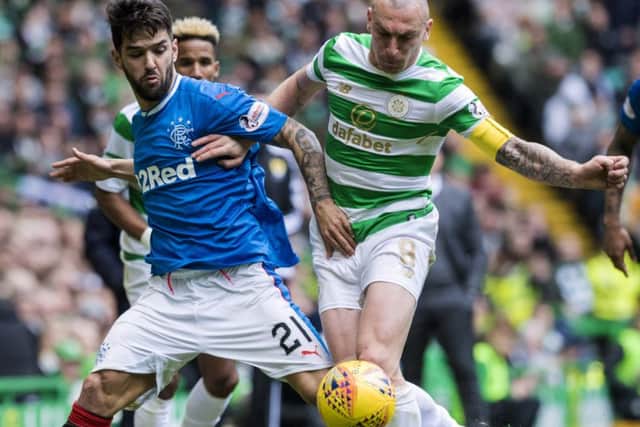 Scott Brown, below, battles for the ball with Rangers' Daniel Candeias. Picture: SNS.