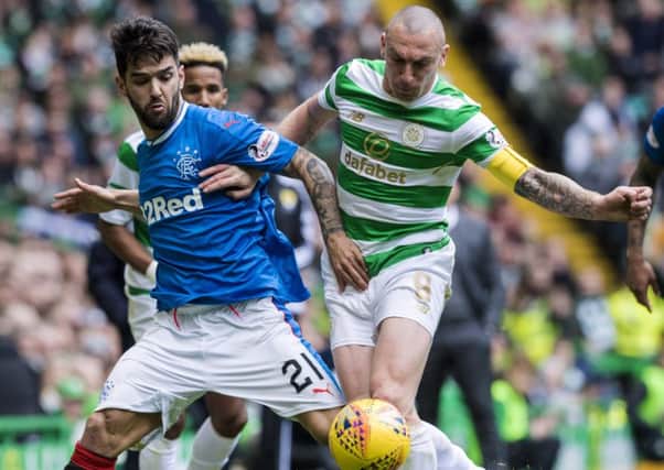 Scott Brown, below, battles for the ball with Rangers' Daniel Candeias. Picture: SNS.