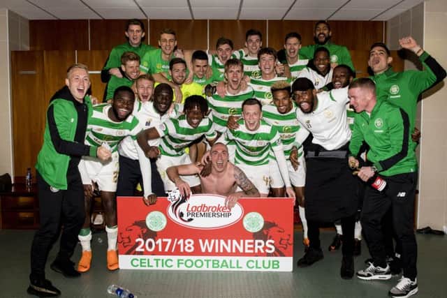 A shirtless Scott Brown leads his players in celebration after clinching the league title yesterday. Picture: SNS.