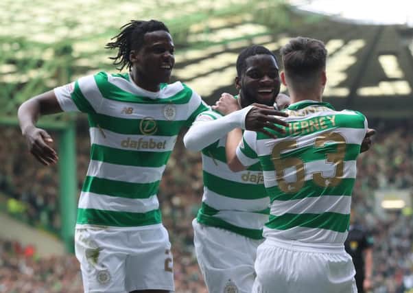 Dedryck Boyata and Kieran Tierney celebrate with Odsonne Edouard, centre, after the striker's opening goal. Picture: Getty