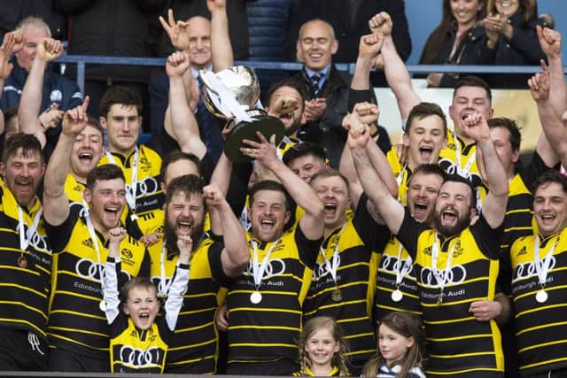 Melrose captain Grant Runciman, centre, lifts the BT Cup at Murrayfield. Picture: SNS/SRU.