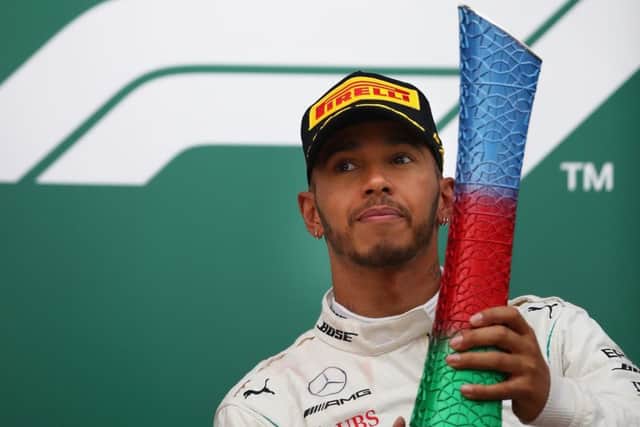 Lewis Hamilton  hoists his trophy after his victory in Baku. Picture: Getty.