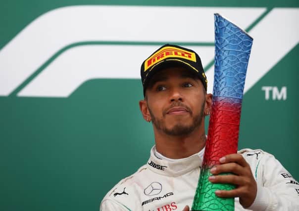 Lewis Hamilton  hoists his trophy after his victory in Baku. Picture: Getty.
