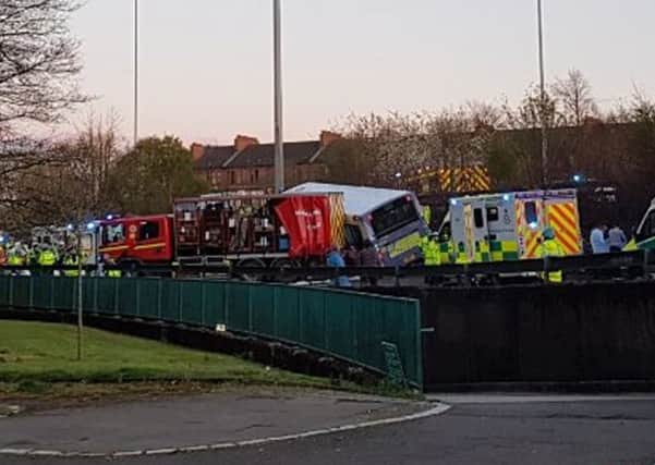 The scene of a bus crash on a slip road near the Clyde Tunnel at around 7pm on Sunday. Picture: Feargal Dalton/PA Wire