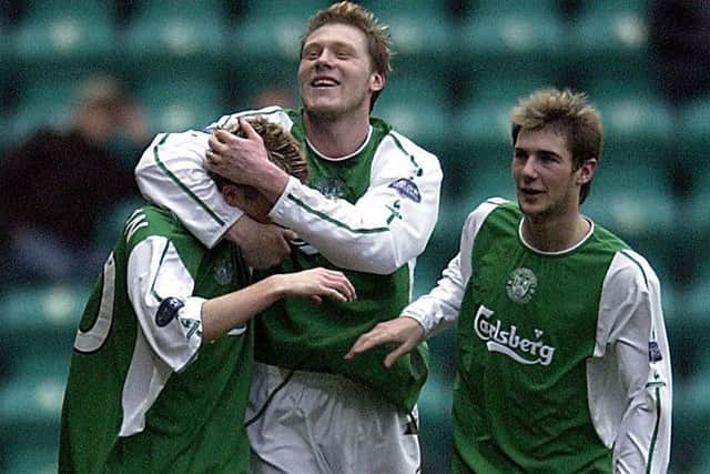 Garry O'Connor embraces Derek Riordan as Kevin Thomson looks on. Picture: Jon Savage