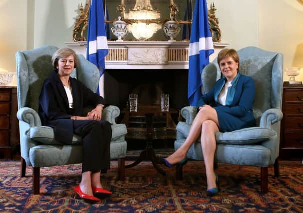 Theresa May and Nicola Sturgeon are on opposite sides of the power grab debate
