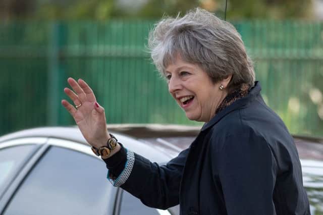 Prime Minister Theresa May waves as she leaves after visiting Brooklands Primary School in Sale, near Manchester. Picture: Oli Scarff/PA Wire
