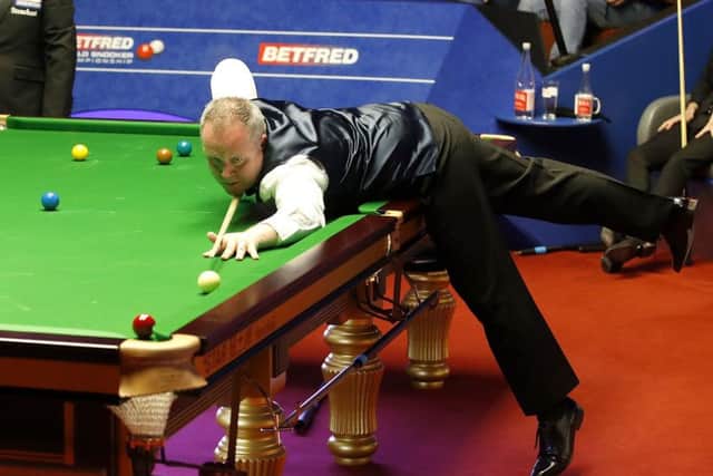 John Higgins poised to pot a red against Judd Trump. Picture: Martin Rickett/PA Wire