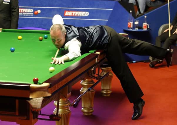 John Higgins poised to pot a red against Judd Trump. Picture: Martin Rickett/PA Wire
