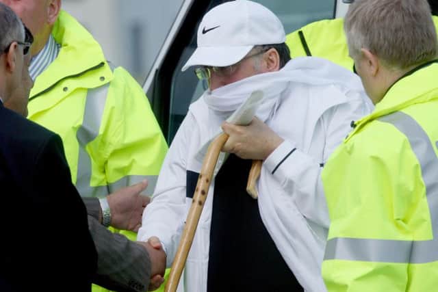 Lockerbie bomber Abdelbaset Ali Mohmed Al Megrahi leaves a police van before he boards a plane at Glasgow Airport in 2009, after he was released on compassionate grounds by Scottish Justice Secretary Kenny MacAskill.