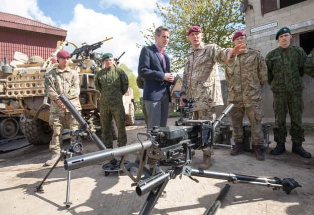 Defence Secretary Gavin Williamson (centre) talks with members of the Parachute Regiment at a live demonstration being held on Salisbury Plain. Picture: Matt Cardy/Getty Images