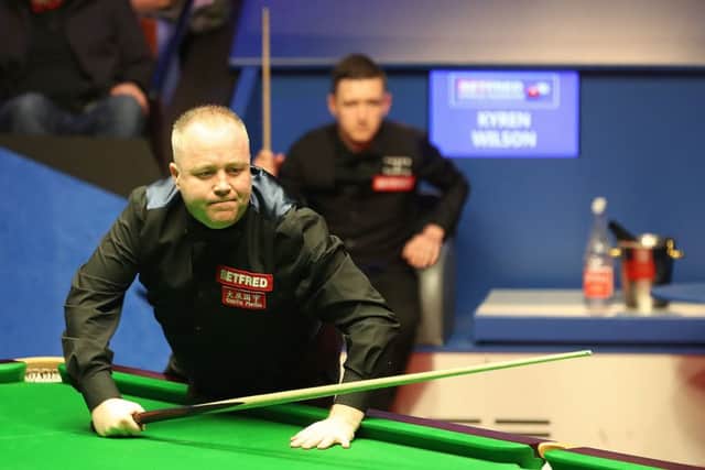 John Higgins surveys the table, while Kyren Wilson watches on, as the two battle for a place in the World Snooker Championship final. Picture: PA