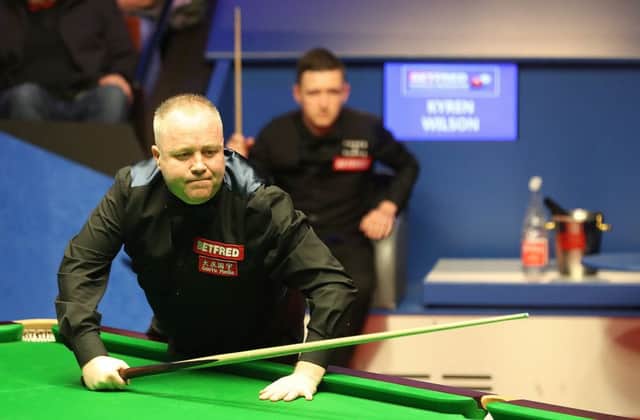 John Higgins surveys the table, while Kyren Wilson watches on, as the two battle for a place in the World Snooker Championship final. Picture: PA