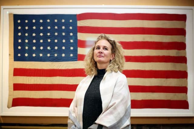Jennifer Jones from the Smithsonian Museum in Washington DC alongside the flag on show at the Museum of Islay Life. Picture: Jane Barlow/PA Wire