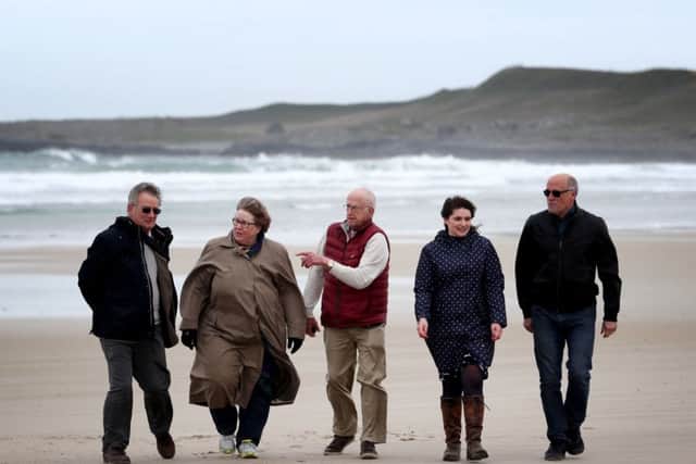 EMBARGOED TO 0001 FRIDAY MAY 4

(left to right) Nick Hide, Lynne Vandertie, John Roberts, Morvern McPhee and Mark Jabbusch, direct descendants of the crew and survivors from the HMS Otranto disaster, which sank in 1918 off the coast of Islay, walk along Kilchoman beach on the island where many bodies were washed up. PRESS ASSOCIATION Photo. Picture date: Thursday May 3, 2018. A service has been held at sea to remember around 700 First World War soldiers who lost their lives in the sinking of two US ships off the coast of a small Scottish island. The SS Tuscania and HMS Otranto sunk off the coast of Islay within eight months of each other in 1918, with almost 700 people dying. See PA story MEMORIAL Islay. Photo credit should read: Jane Barlow/PA Wire