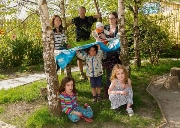 Gardener Ash Watt with Lynne Smith and Erin(6) and Juli Critchley with Imogen (5 mths) Isla (6) and Magnus (3) at the sensory garden at The Link in Loanhead.