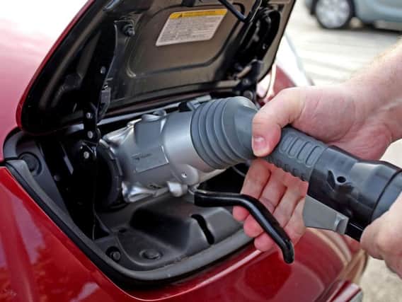 A car fills up with diesel at a petrol pump.