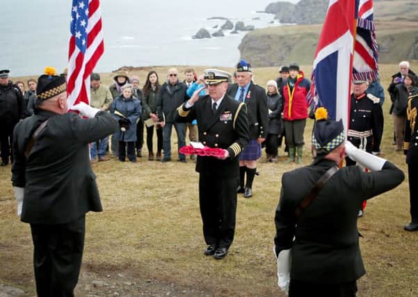 Captain Mark Rudesill, naval attache, United States Navy, lays a wreath during a service at the American Moment at the Mull of Oa on Islay, to remember around 700 First World War soldiers who lost their lives in the sinking of two US ships off the coast of the small Scottish island. Picture: PA