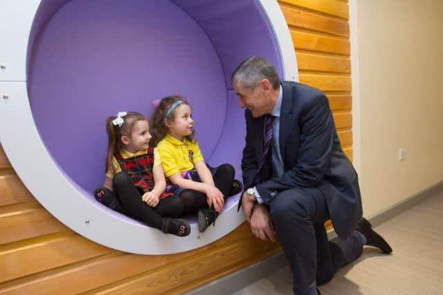 Lilly Quinn and Lily Silberschatz meet Sir Harry Burns at a community centre named after him in Barrhead. Picture: Mark F Gibson