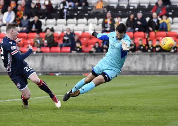 Billy Mckay fires Ross Countys equaliser past Partick goalkeeper Tomas Cerny to keep his sides slim survival hopes alive. Picture: SNs.