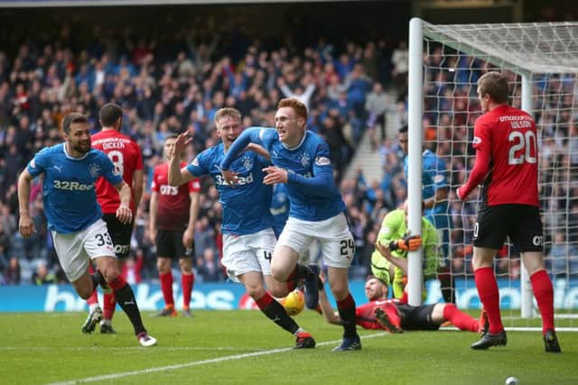David Bates (centre) celebrates scoring the winner for Rangers. Picture: PA