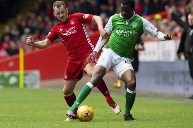 Efe Ambrose and Niall McGinn battle for the ball at Pittodrie. Picture: SNS Group