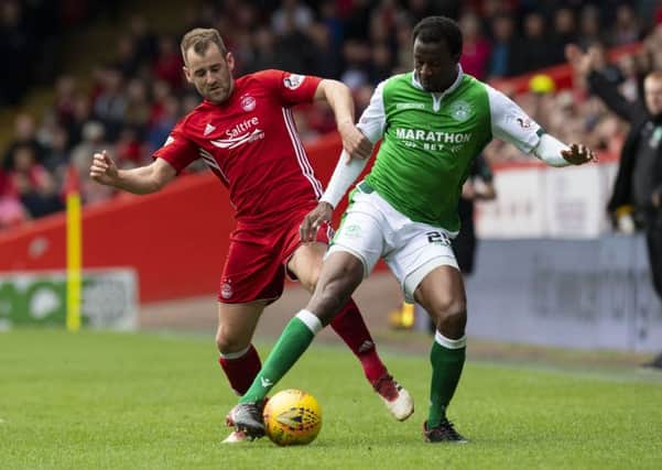 Efe Ambrose and Niall McGinn battle for the ball at Pittodrie. Picture: SNS Group