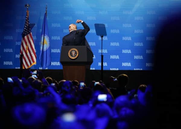 Donald Trump clowns around to the delight of NRA members at the Kay Bailey Hutchison Convention Center in Dallas, Texas. Picture: Loren Elliot/Getty