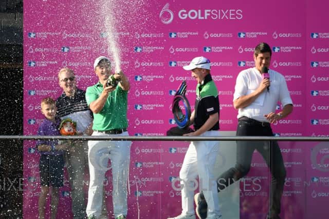 Gavin Moynihan, centre, holds the trophy as his team-mate Paul Dunne sprays champagne and sends host Vernon Kay scurrying. Picture: Getty.