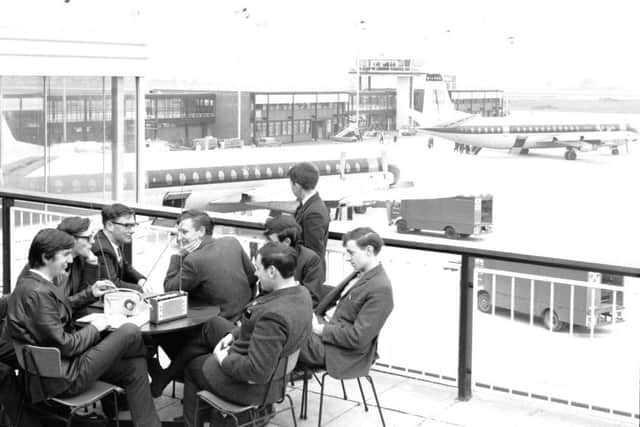 Plane-spotters listening to air traffic control on the spectators' gallery at Abbotsinch Airport. PIC: TSPL.
