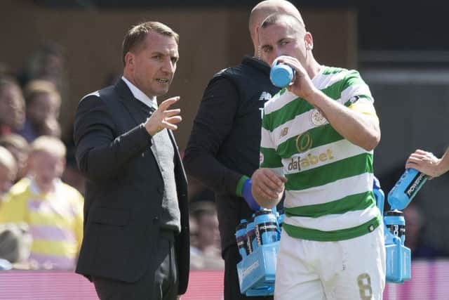 Celtic manager Brendan Rodgers takes a moment to speak to Scott Brown during the win over Hearts. Picture: Craig Williamson/SNS