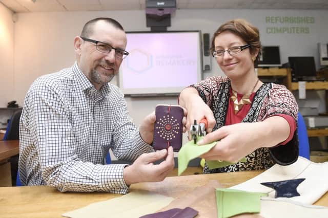 Iain Gulland, chief executive of Zero Waste Scotland, with Helen Stephenson, who creates items from recycled leather. Picture: Greg Macvean