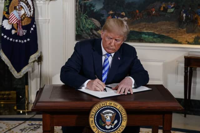 President Donald Trump signs a Presidential Memorandum on the Iran nuclear deal. Picture :AP Photo/Evan Vucci