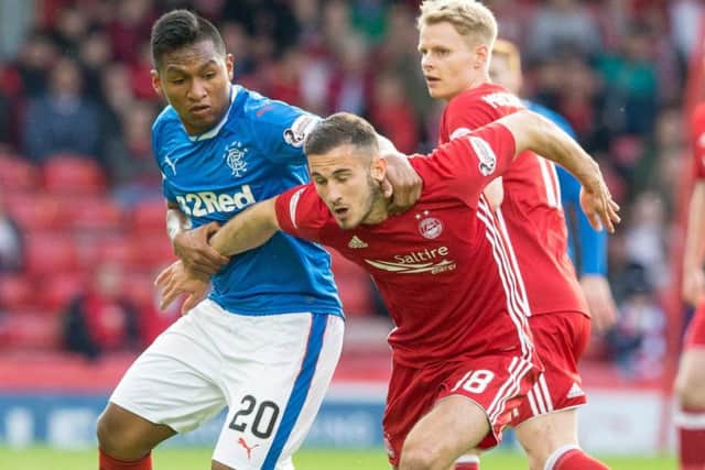 Aberdeen's Dominic Ball tangles with Rangers' Alfredo Morelos during the 1-1 draw at Pittodrie on Tuesday night. Pic: SNS