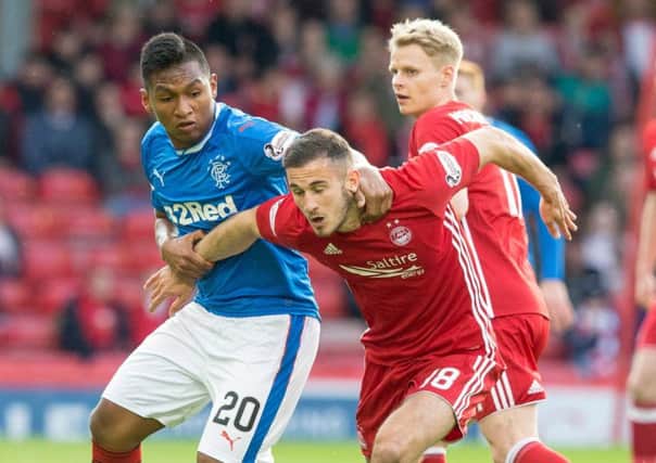 Aberdeen's Dominic Ball tangles with Rangers' Alfredo Morelos during the 1-1 draw at Pittodrie on Tuesday night. Pic: SNS