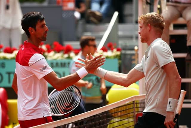 Kyle Edmund, right, and Novak Djokovic at the net after the Briton's win over the Serb in Madrid. Picture: Clive Brunskill/Getty Images