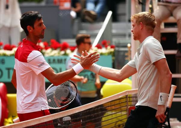 Kyle Edmund, right, and Novak Djokovic at the net after the Briton's win over the Serb in Madrid. Picture: Clive Brunskill/Getty Images