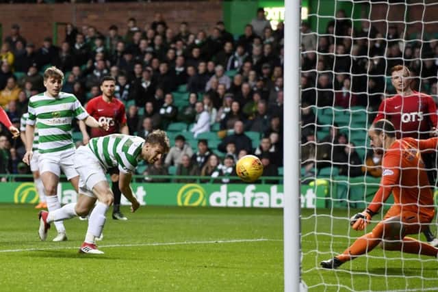Celtic midfielder Stuart Armstrong watches as Kilmarnock goalkeeper Jamie MacDonald dives to save his close-range effort. Picture: SNS