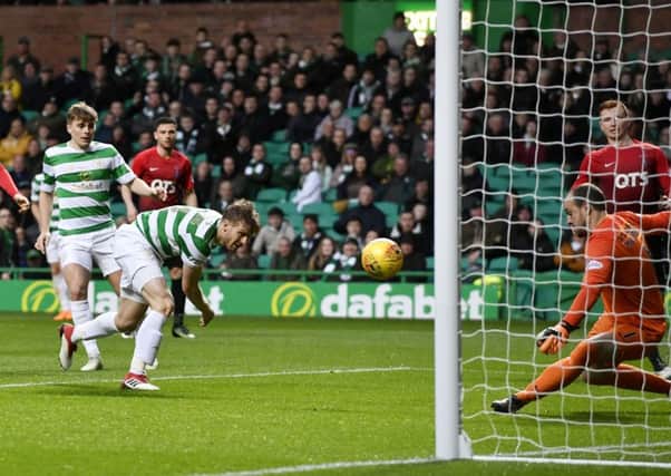 Celtic midfielder Stuart Armstrong watches as Kilmarnock goalkeeper Jamie MacDonald dives to save his close-range effort. Picture: SNS