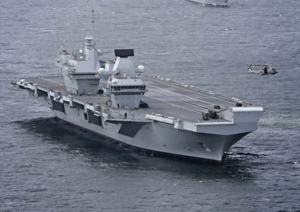 The HMS Queen Elizabeth is a potent symbol of British military power (Picture: PA)
