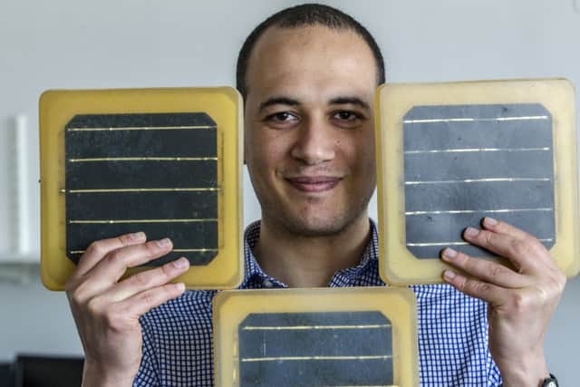 Dr Azmy Gowaid of Glasgow Caledonian University with the tiles, which are epoxy resin based rather than glass. Picture: Peter Devlin