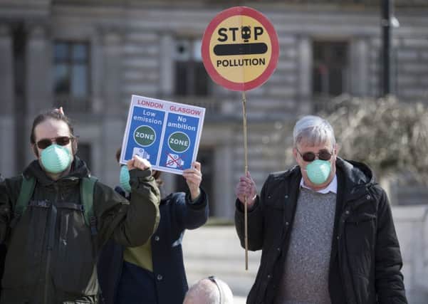 Protesters in gas masks stage a 'die-in' amid claims Glasgow's plans to tackle air pollution are too weak (Picture: John Devlin)