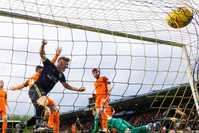 Alan Lithgow, left, heads Livingston into an early lead. United equalised but it was the West Lothian side who reached the Play-Off final. Picture: SNS.