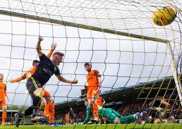 Alan Lithgow, left, heads Livingston into an early lead. United equalised but it was the West Lothian side who reached the Play-Off final. Picture: SNS.