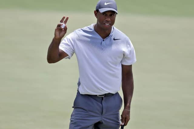 Tiger Woods waves on the 18th green during the third round of the Players Championship. Picture: Lynne Sladky/AP