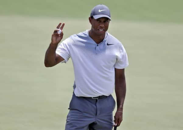 Tiger Woods waves on the 18th green during the third round of the Players Championship. Picture: Lynne Sladky/AP